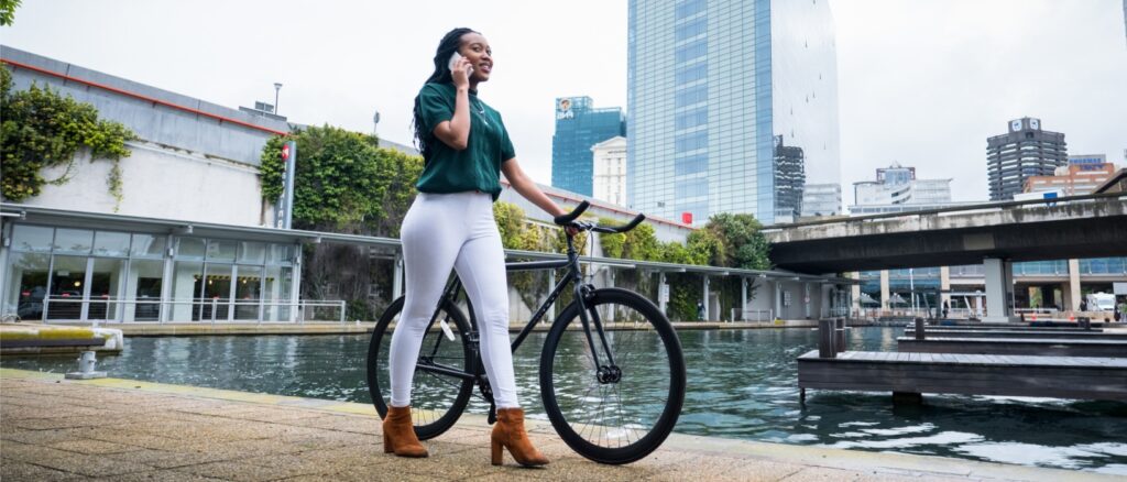 woman walking with bike commuting to work