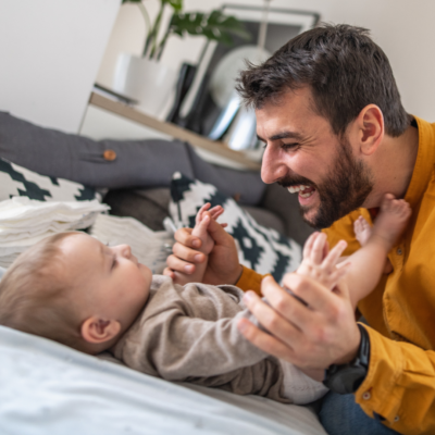 Man smiling and holding baby